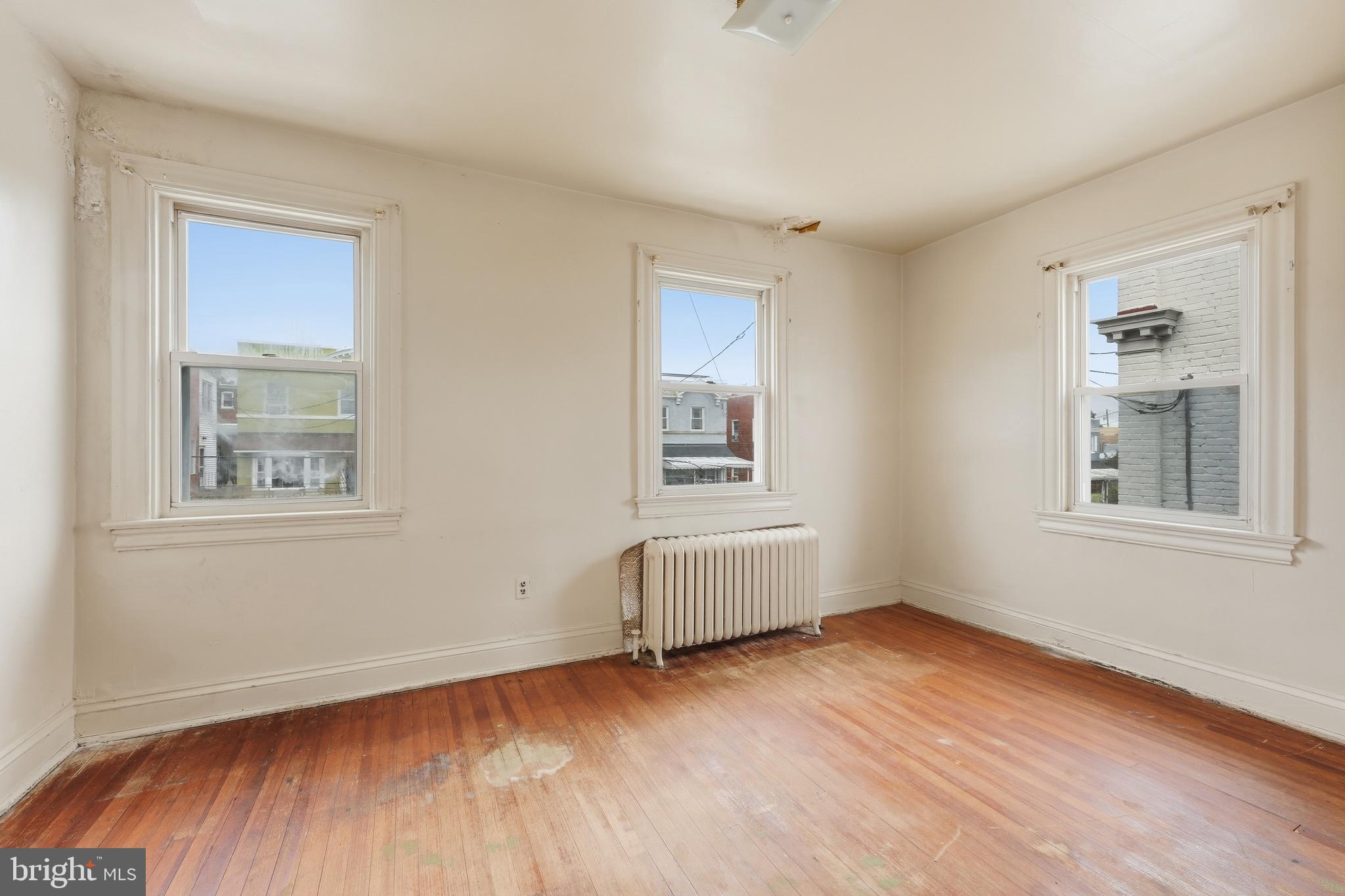 726 Somerset Place Northwest Washington, DC 20011 - Photo 20 of 28 a view of an empty room with wooden floor and a window