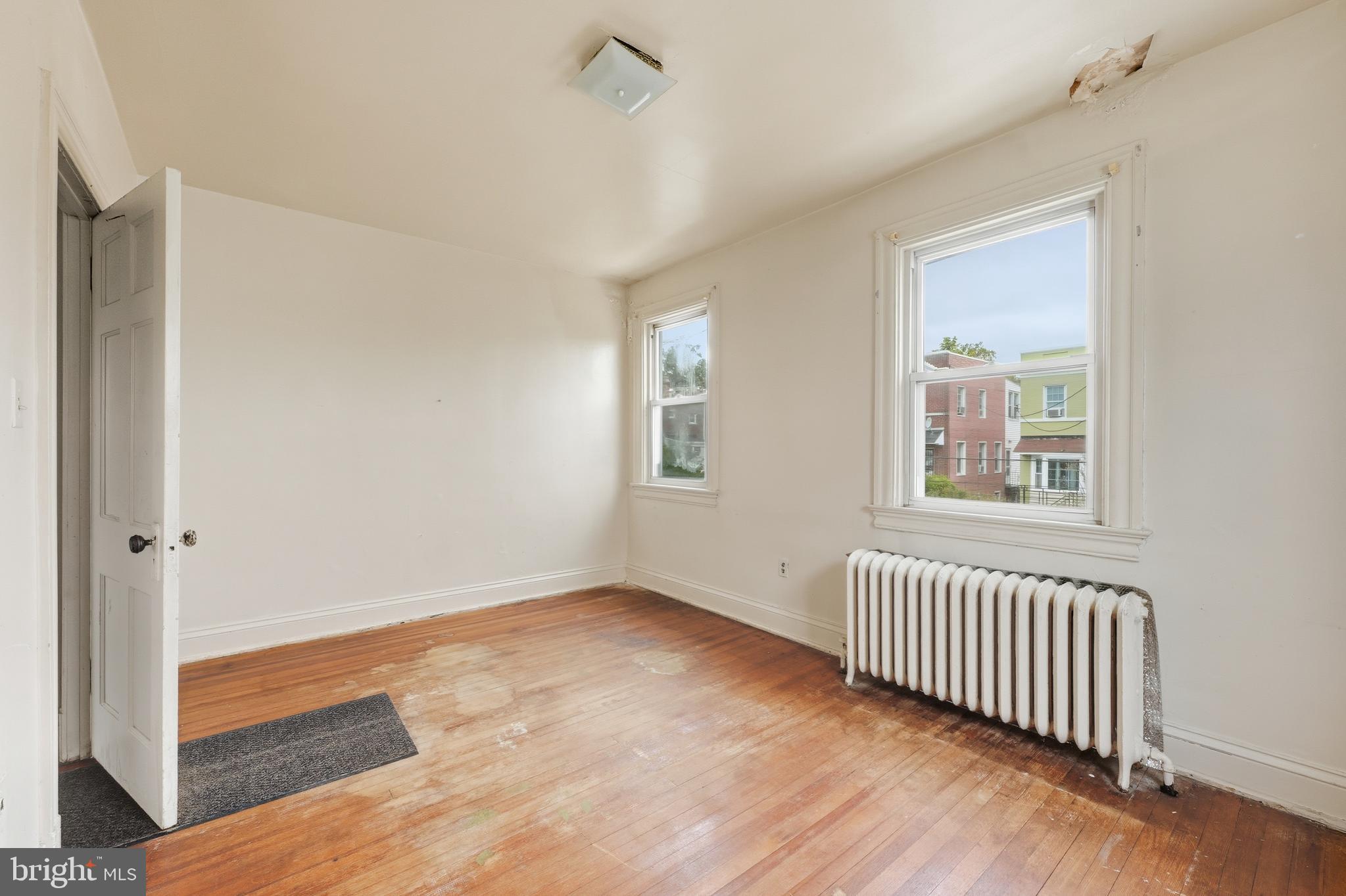 726 Somerset Place Northwest Washington, DC 20011 - Photo 21 of 28 a view of an empty room with wooden floor and a window