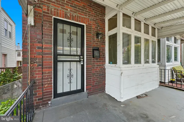 front view of a brick house with a large windows