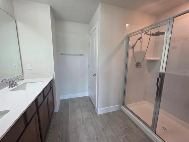 a bathroom with a double vanity sink and a mirror