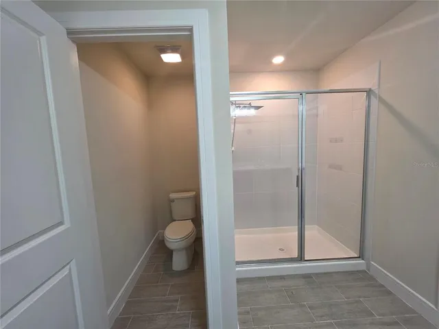 a bathroom with a glass door shower