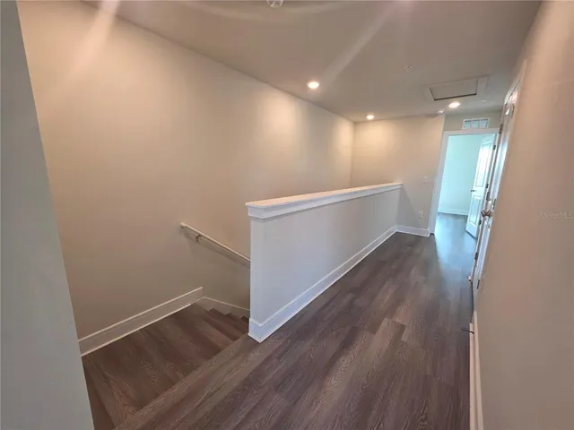 a view of hallway with wooden floor