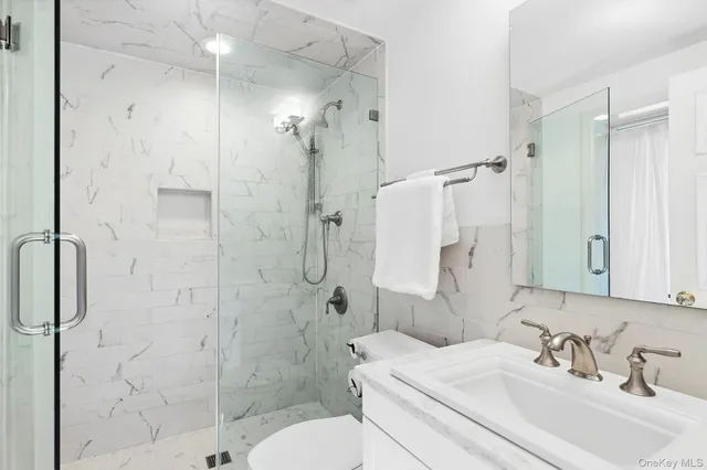 a bathroom with a sink toilet and shower