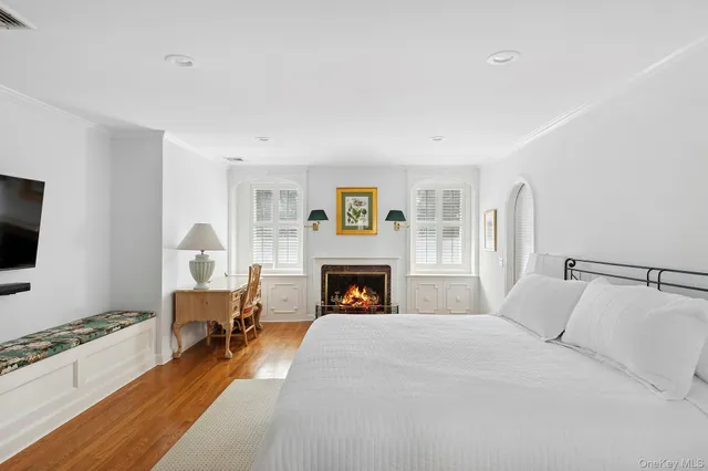 a bedroom with a bed and a fireplace