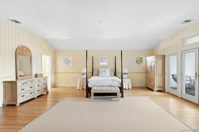 a spacious bedroom with a bed and a walk in closet