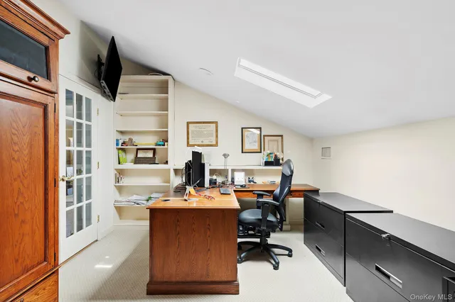 a room with stainless steel appliances kitchen island furniture and a flat screen tv