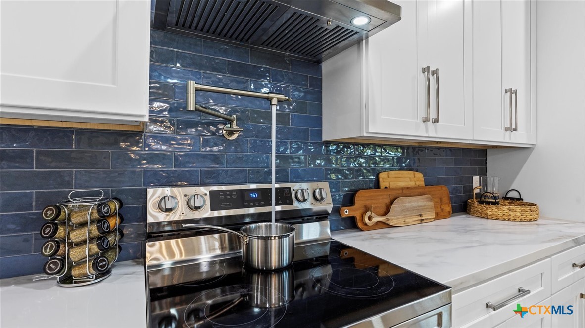 6786 River Road New Braunfels, TX 78132 - Photo 11 of 38 a kitchen with a sink and cabinets