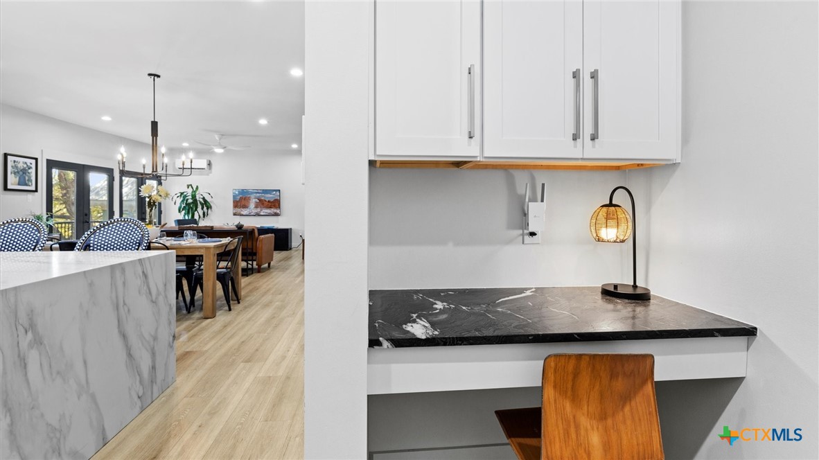 6786 River Road New Braunfels, TX 78132 - Photo 12 of 38 a kitchen with stainless steel appliances granite countertop a sink a stove and a wooden floors