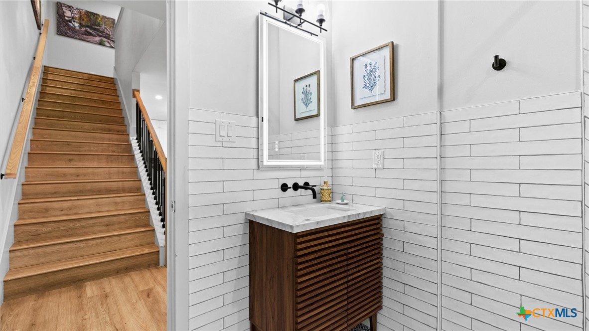 6786 River Road New Braunfels, TX 78132 - Photo 16 of 38 a bathroom with a sink and a mirror