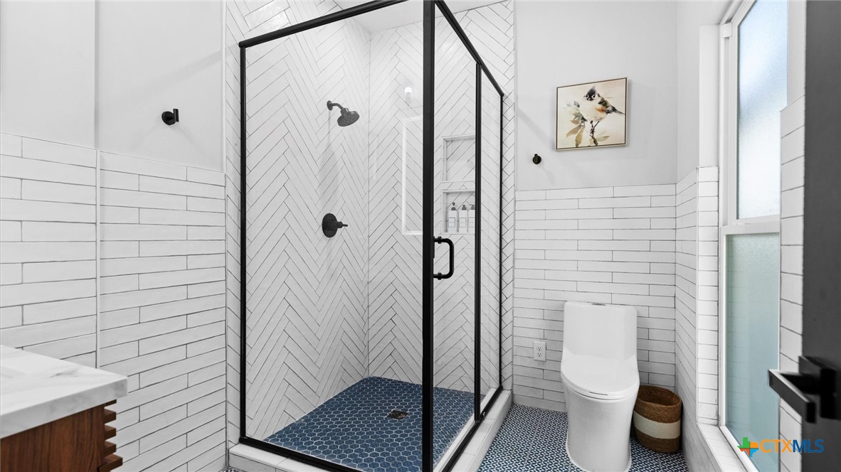 6786 River Road New Braunfels, TX 78132 - Photo 17 of 38 a bathroom with a toilet and a shower