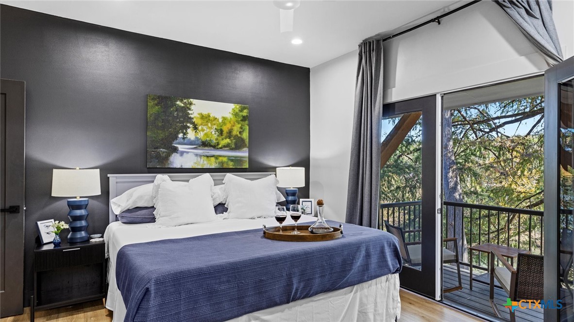 6786 River Road New Braunfels, TX 78132 - Photo 18 of 38 a bedroom with a bed and a large window