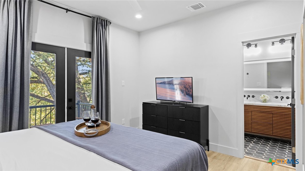 6786 River Road New Braunfels, TX 78132 - Photo 19 of 38 a bedroom with a bed and a dresser