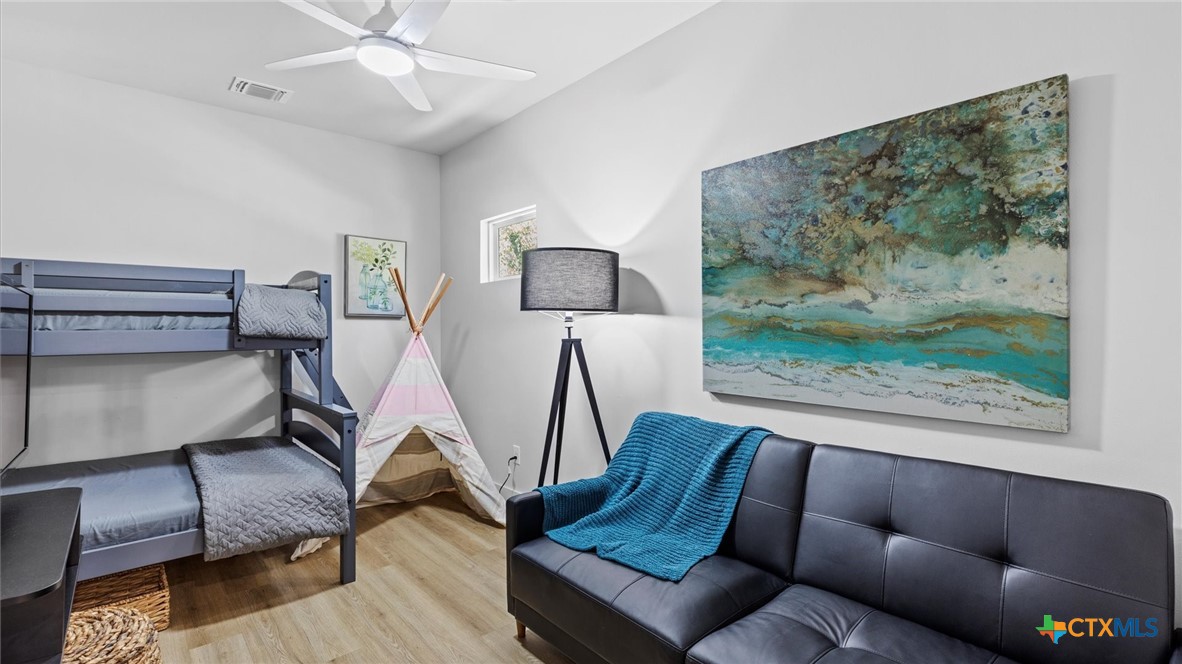 6786 River Road New Braunfels, TX 78132 - Photo 22 of 38 a living room with furniture and a painting on the wall