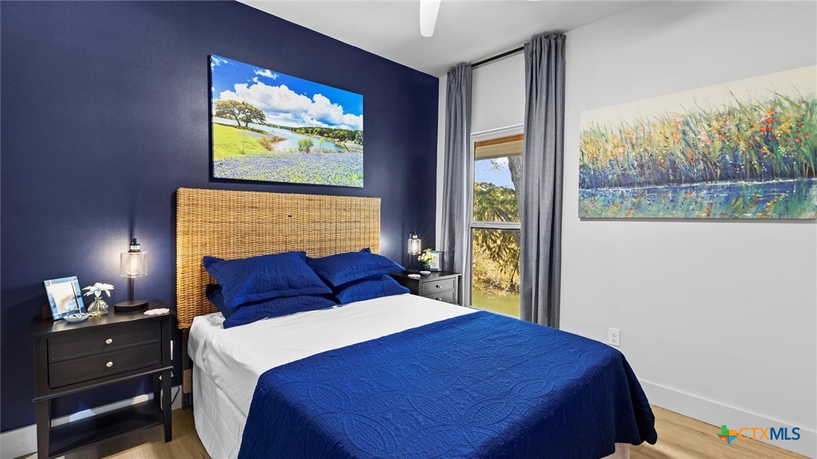 6786 River Road New Braunfels, TX 78132 - Photo 23 of 38 a bedroom with a bed and a painting on the wall