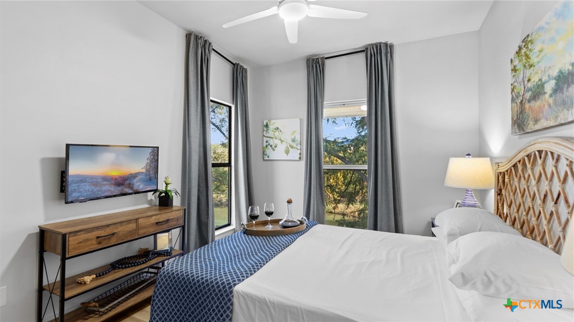 6786 River Road New Braunfels, TX 78132 - Photo 24 of 38 a bedroom with furniture and a flat screen tv