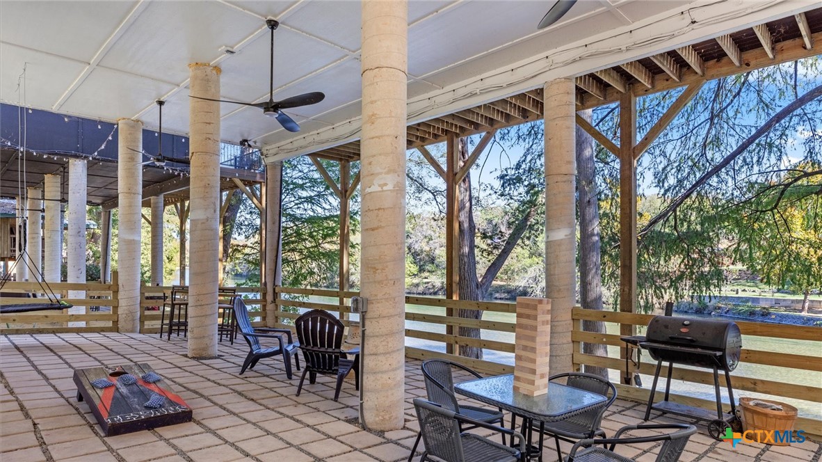 6786 River Road New Braunfels, TX 78132 - Photo 26 of 38 a view of a patio with a table and chairs