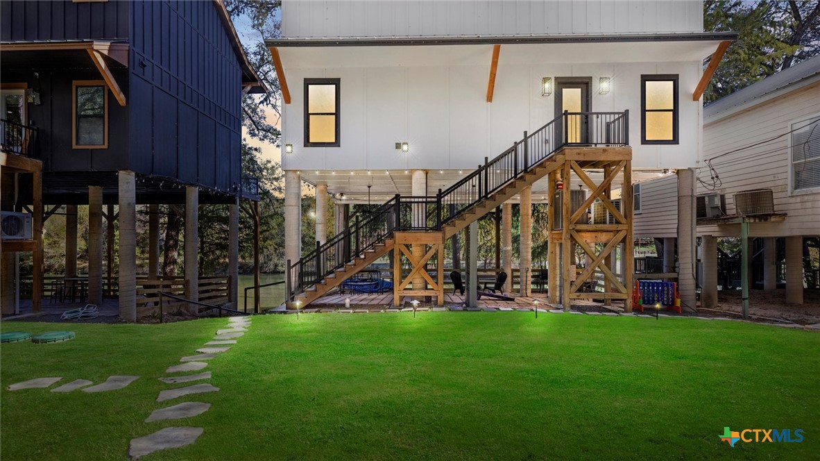 6786 River Road New Braunfels, TX 78132 - Photo 32 of 38 a view of a house with a yard and sitting area