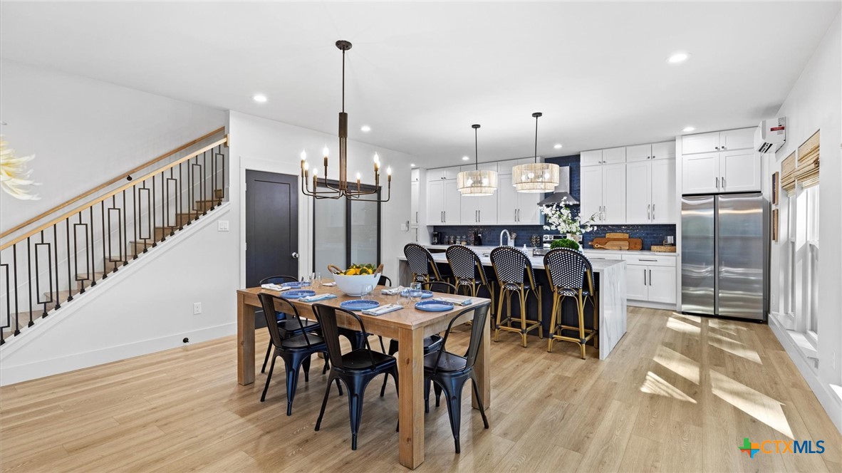 6786 River Road New Braunfels, TX 78132 - Photo 6 of 38 a kitchen with stainless steel appliances kitchen island granite countertop a table chairs and a refrigerator