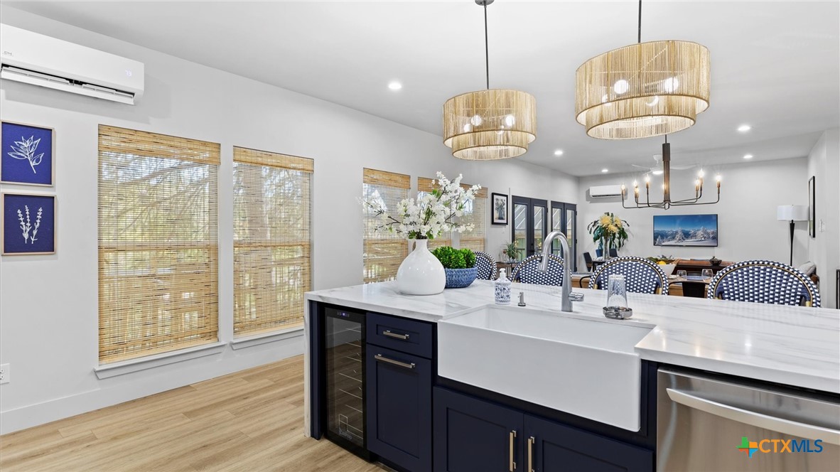 6786 River Road New Braunfels, TX 78132 - Photo 9 of 38 a kitchen with stainless steel appliances granite countertop a sink and wooden floor