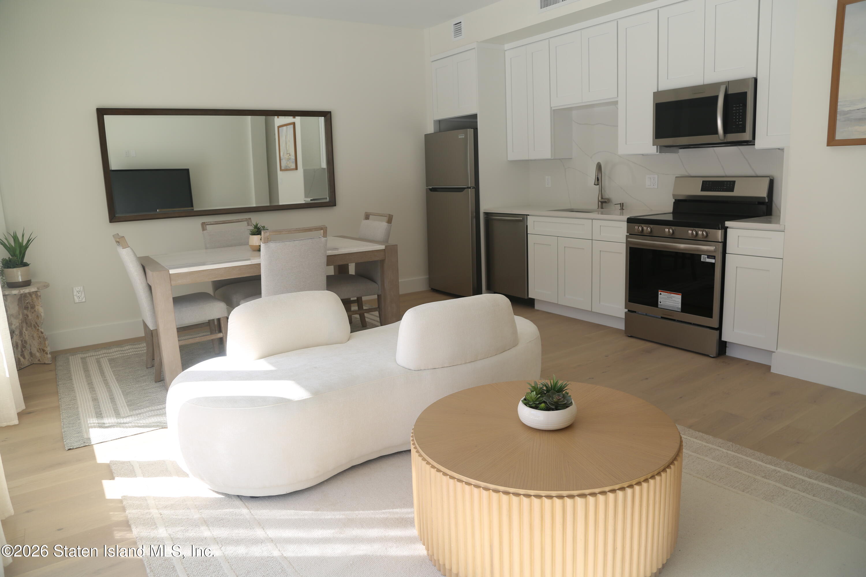 1239 Forest Hill Road, Unit 7 Staten Island, NY 10314 - Photo 4 of 14 a living room with furniture and a fireplace