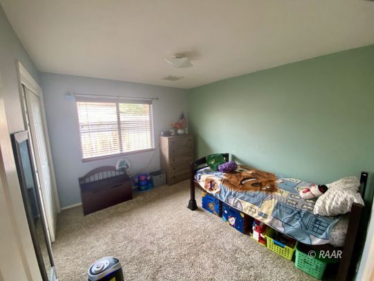 813 Charles Court Ridgecrest, CA 93555 - Photo 11 of 20 a bedroom with bed and a window