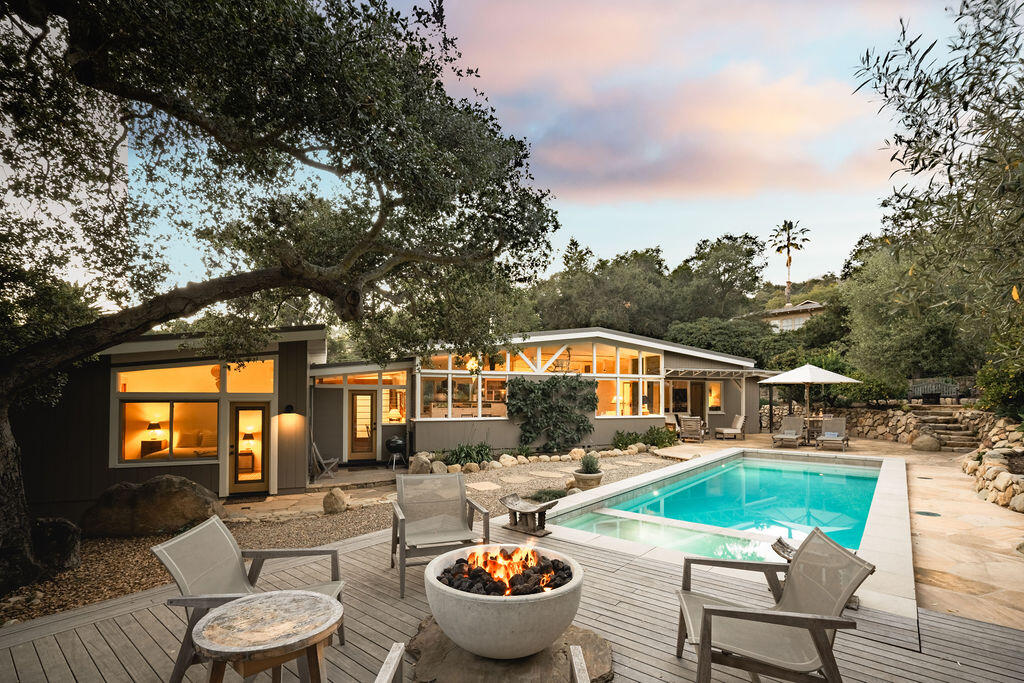 a view of a patio with couches table and chairs and potted plants