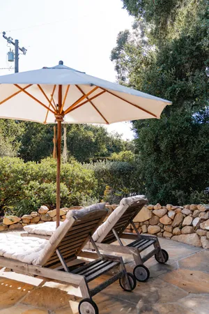 a view of backyard with swimming pool and outdoor seating