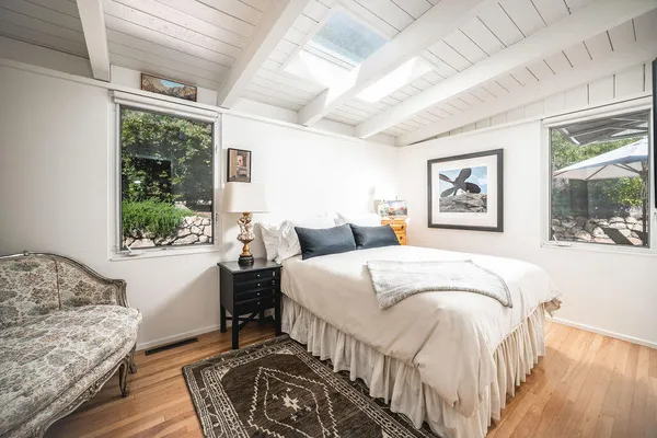 a bedroom with a large bed and a window