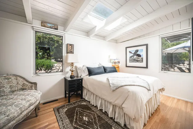 a bedroom with a large bed and a window