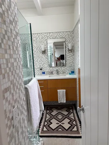 a room with a sink and a mirror