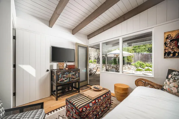 a bedroom with furniture and a flat screen tv