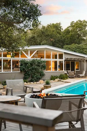 a view of a house with pool porch and chairs
