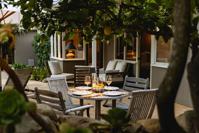 a view of a patio with a table and chairs in a patio
