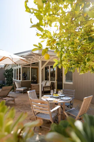a view of a house with backyard sitting area and garage