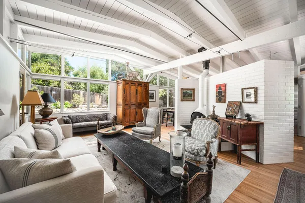 a work room with furniture and a large window