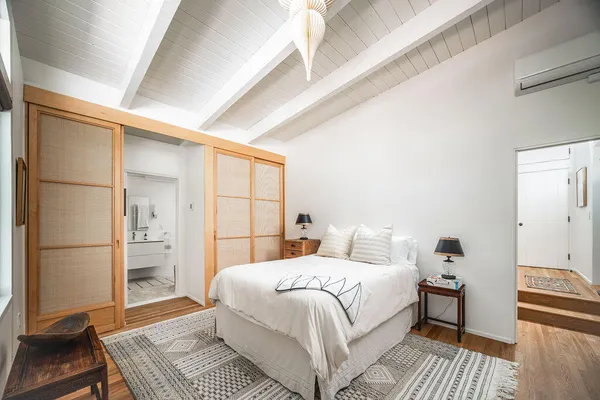 a bedroom with a bed and a table