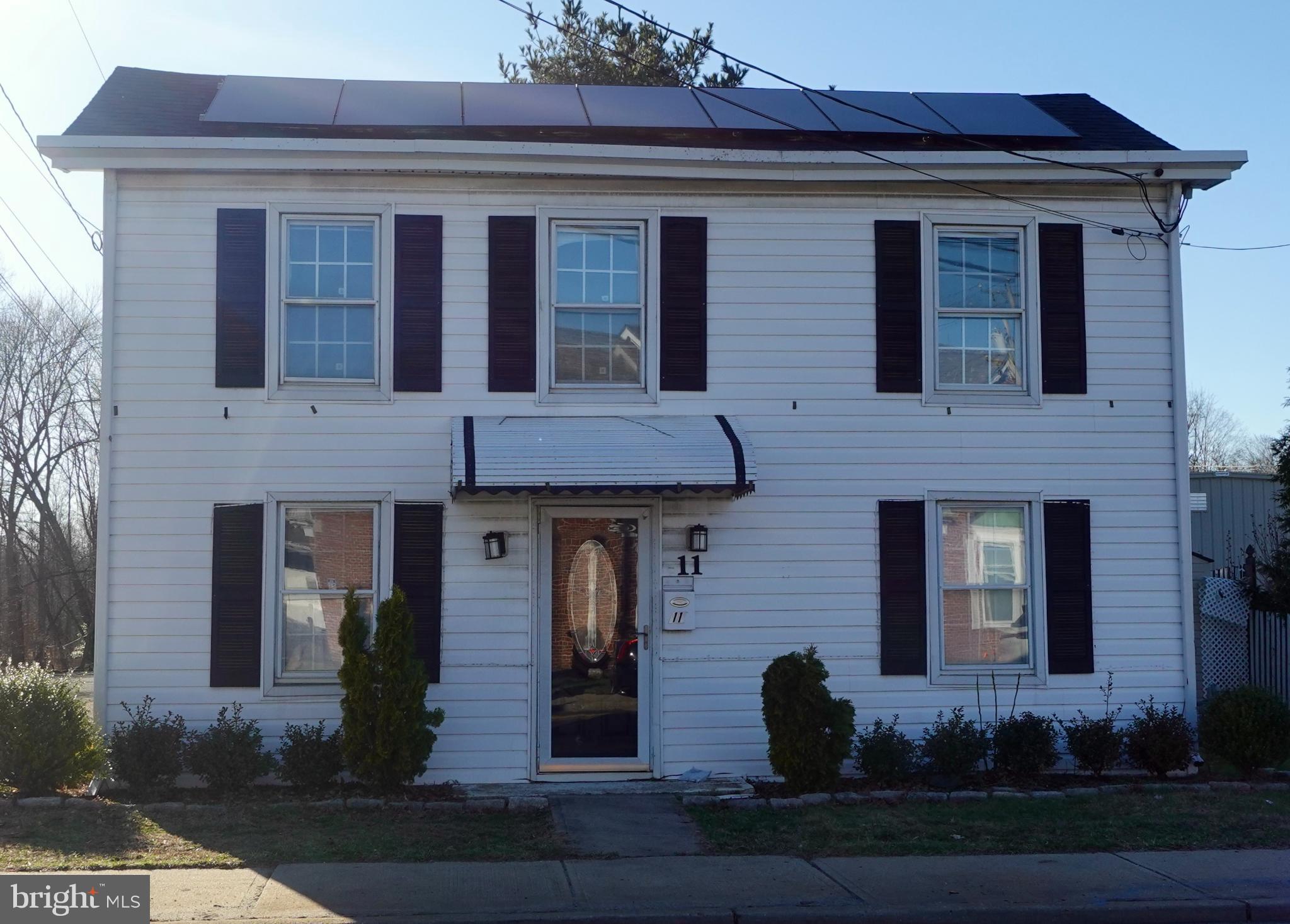 Charming two-story home with solar panels.