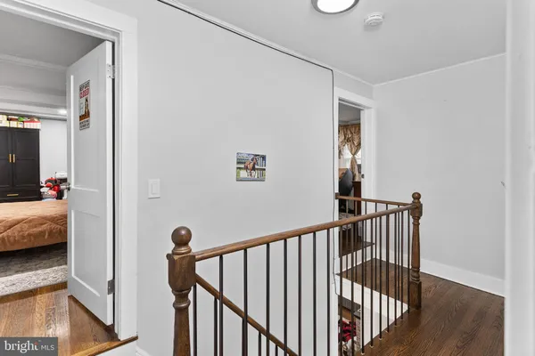 a view of a hallway with bedroom and wooden floor