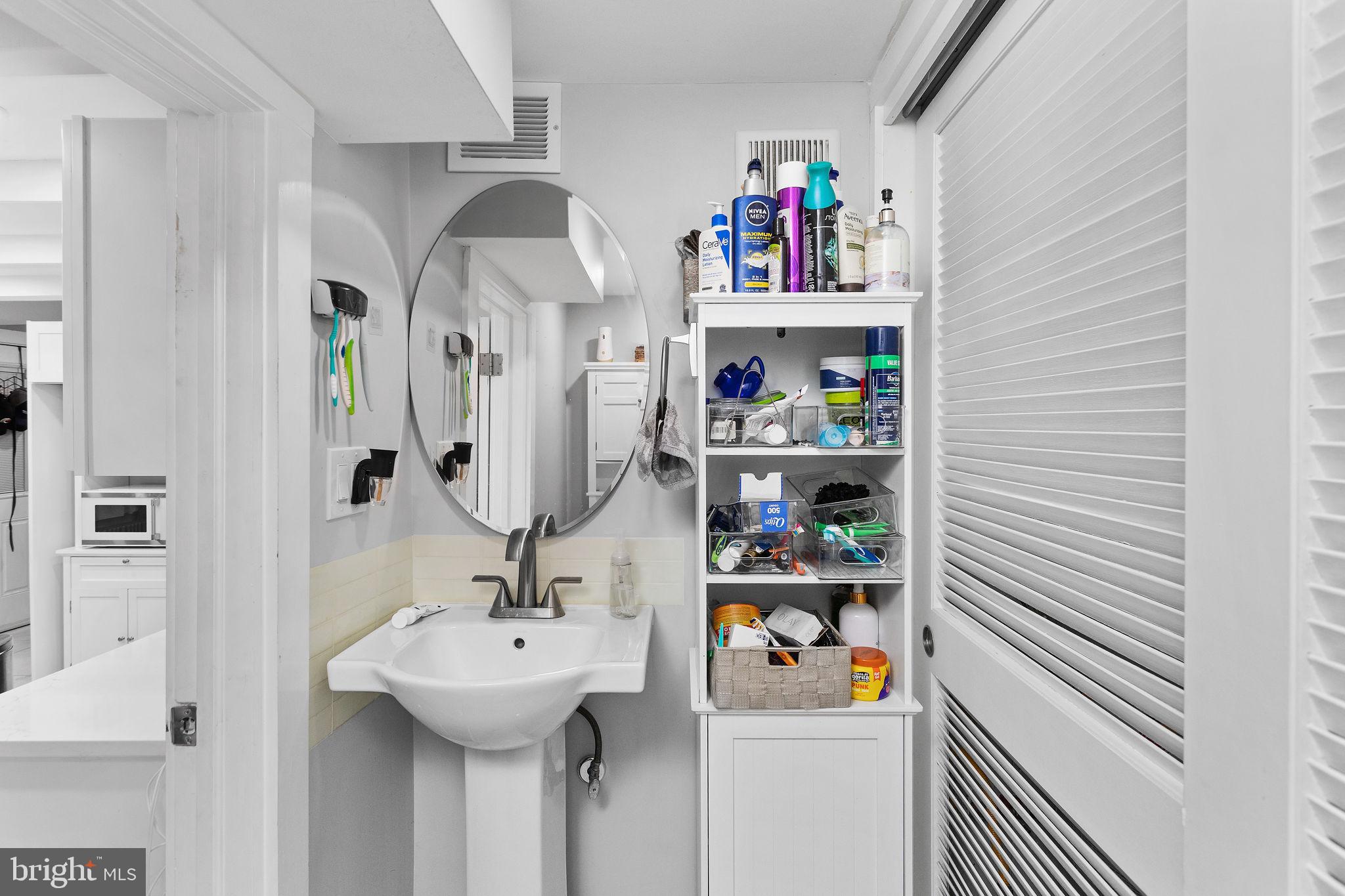 11 Main Street Englishtown, NJ 07726 - Photo 18 of 23 Sleek bathroom with modern storage solutions.