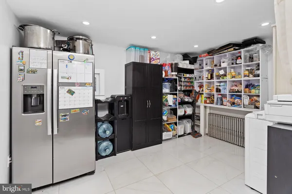 a kitchen with refrigerator and cabinets