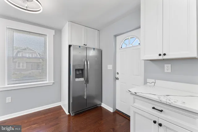 a kitchen with stainless steel appliances granite countertop a refrigerator and a sink