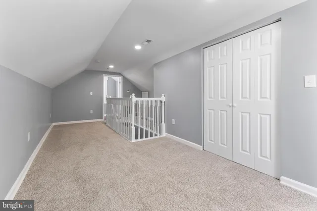 a view of a livingroom with entryway and stairs