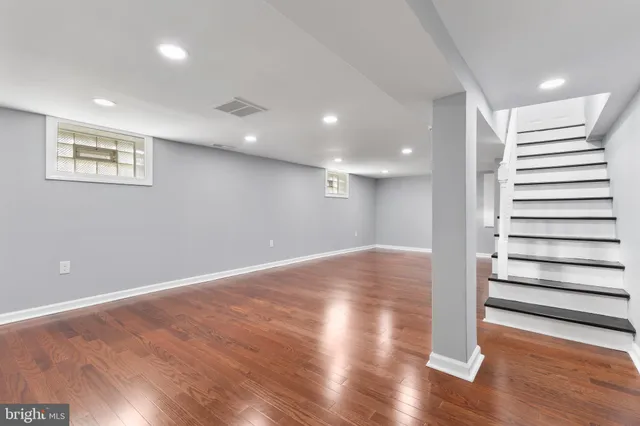 a view of a room with wooden floors and stairs