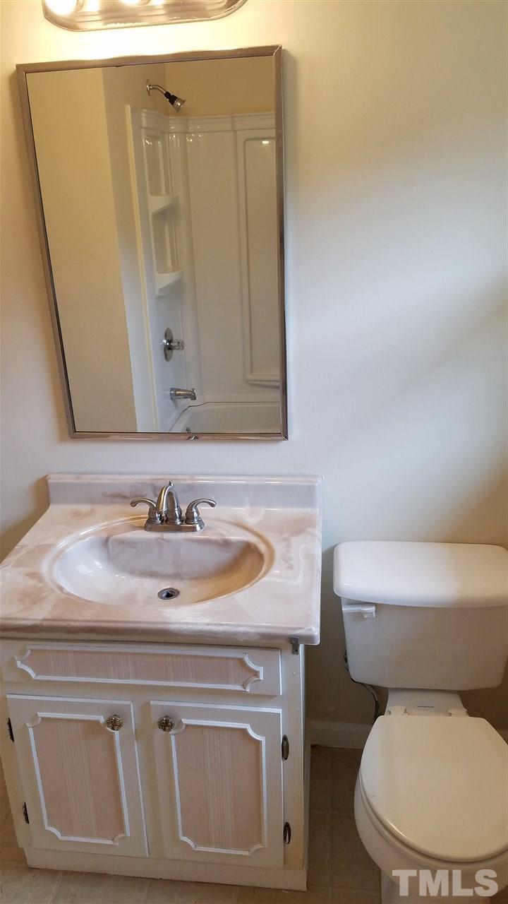 3616 Woodside Road Garner, NC 27529 - Photo 11 of 11 a bathroom with a toilet sink and mirror