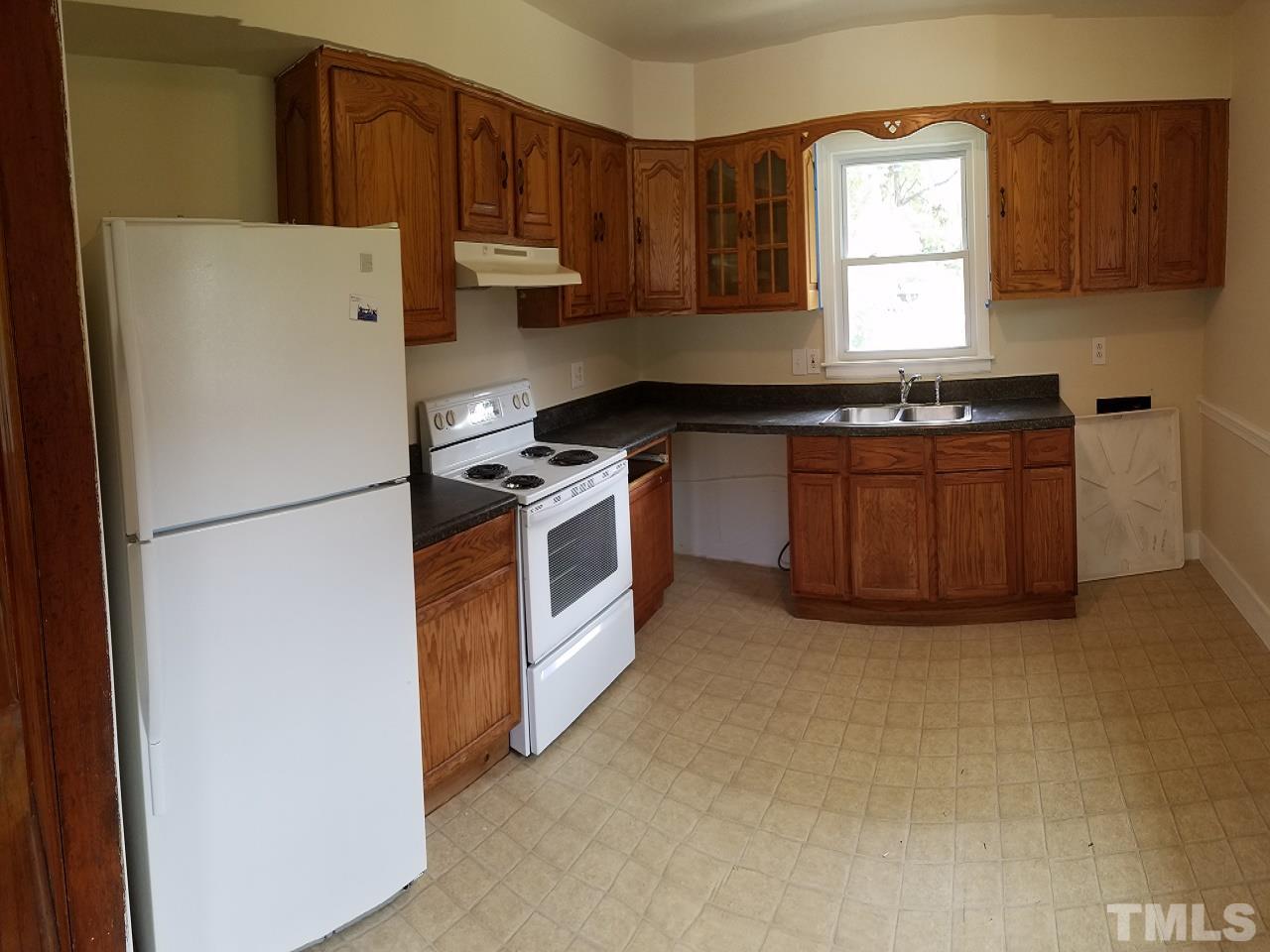 3616 Woodside Road Garner, NC 27529 - Photo 3 of 11 a kitchen with granite countertop a refrigerator stove a sink and dishwasher