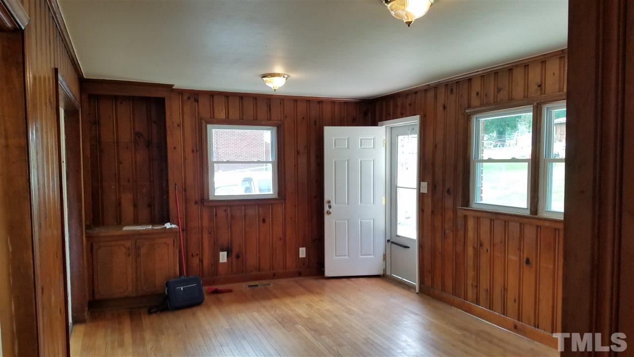 3616 Woodside Road Garner, NC 27529 - Photo 5 of 11 an empty room with wooden floor and windows