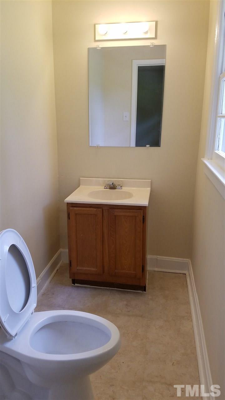 3616 Woodside Road Garner, NC 27529 - Photo 8 of 11 a bathroom with a sink and a mirror