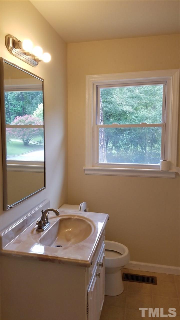 3616 Woodside Road Garner, NC 27529 - Photo 9 of 11 a bathroom with a sink toilet and mirror