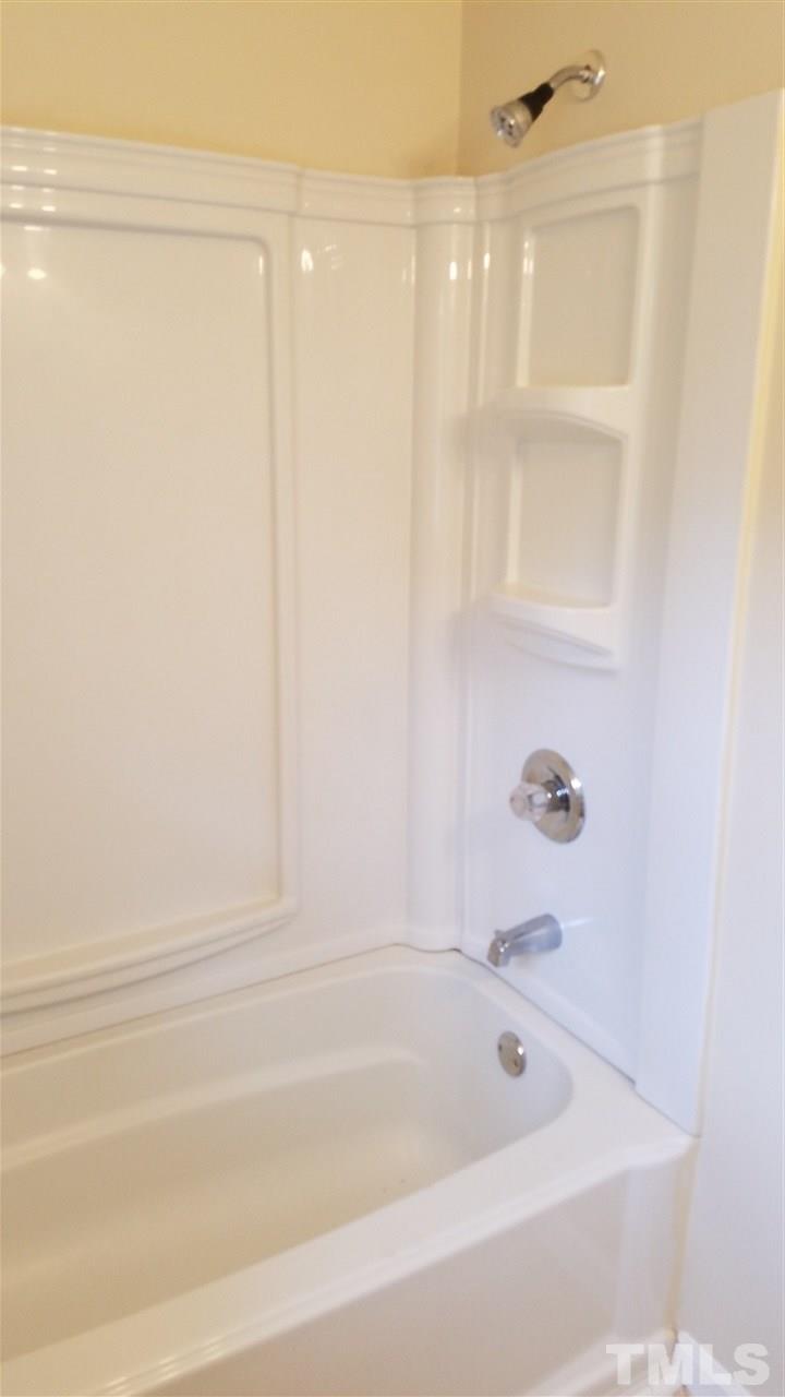 3616 Woodside Road Garner, NC 27529 - Photo 10 of 11 a bathroom with bathtub and window
