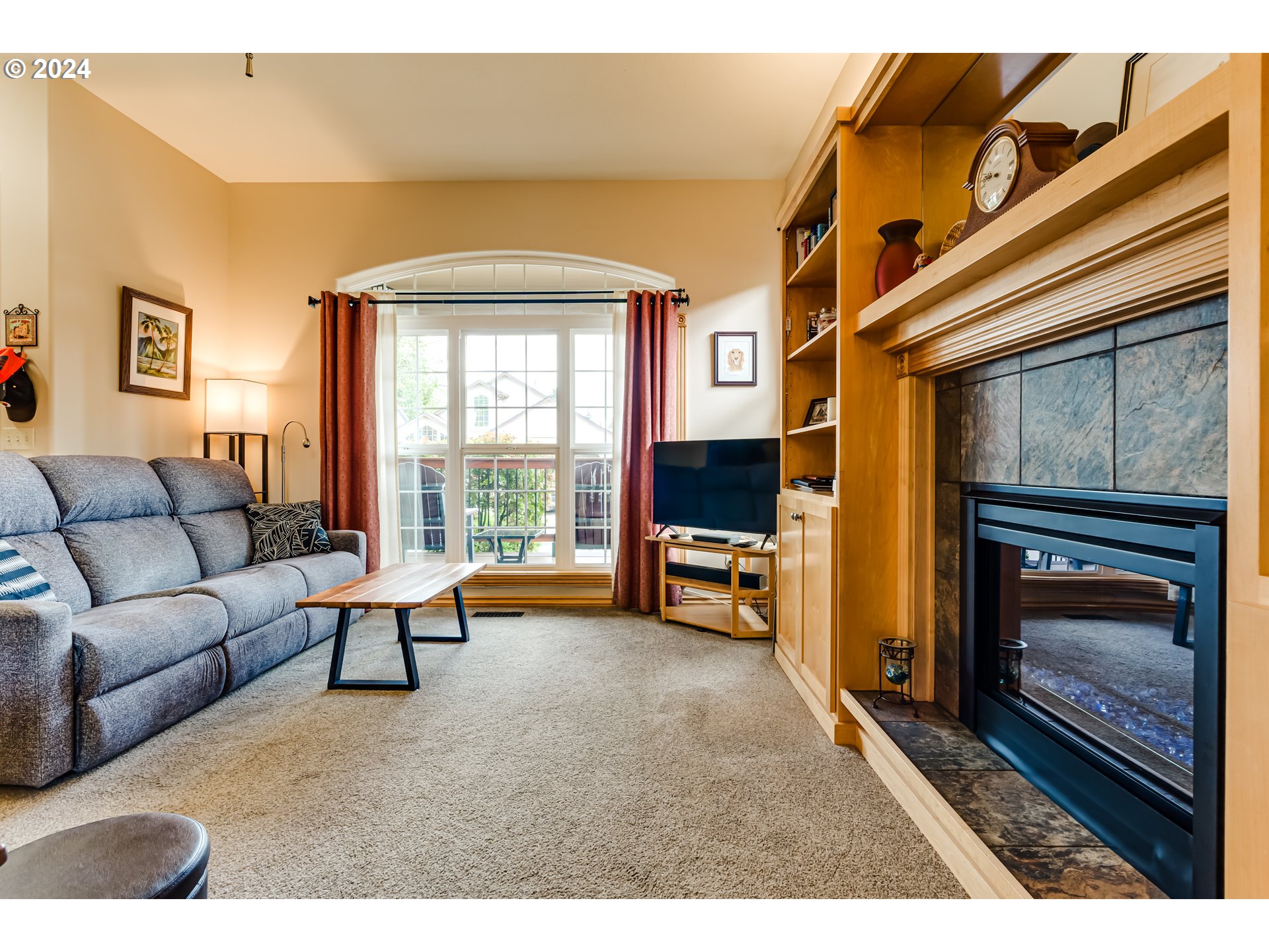 1547 Canal Street Springfield, OR 97477 - Photo 6 of 37 a living room with furniture a flat screen tv and a fireplace